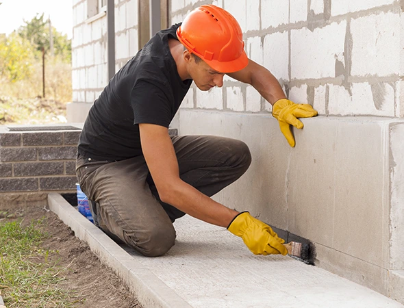Licensed contractor in Tampa performing foundation maintenance and structural repair on a new residential build.