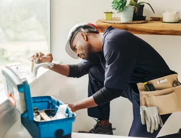 Custom handyman projects in Pearl Beach, MI featuring a technician with a toolbox working on a home repair.